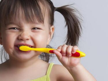 child brushing teeth