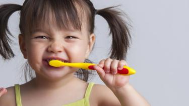 child brushing teeth